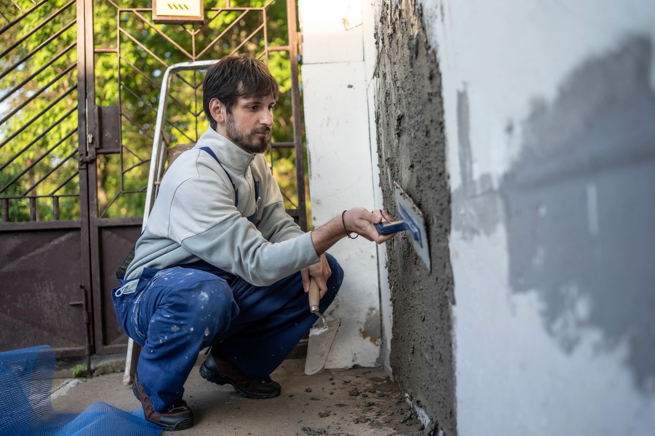 Worker applying finishing compound to wall